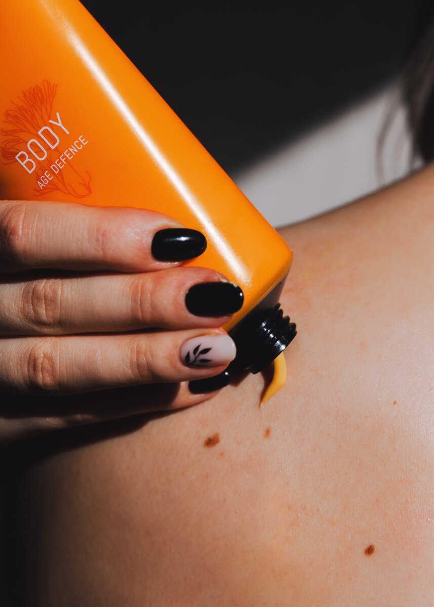 2. Berrichi Age Defence BODY Cream in orange tube, studio shot highlighting packaging design