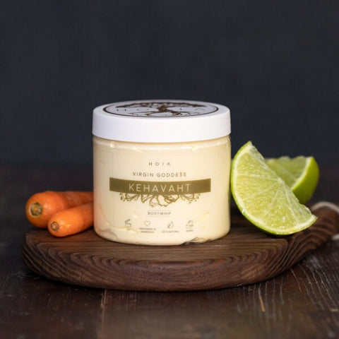 2. HOIA homespa Virgin Goddess Whipped Body Butter jar with lime and carrots on wooden board