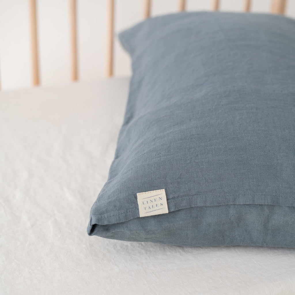 3. Close-up of blue fog linen pillow with Linen Tales label, showcasing fabric texture and brand detail