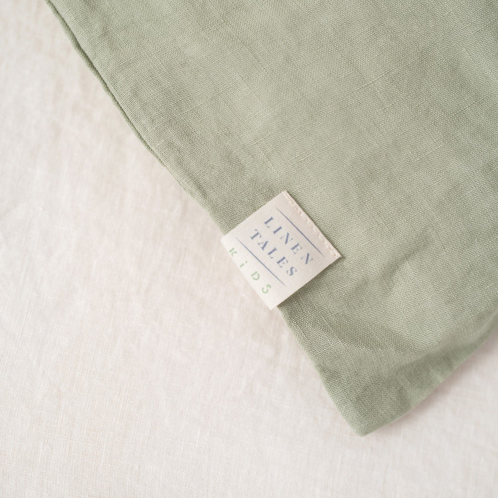 5. Close-up of Linen Tales label on sage green linen pillowcase