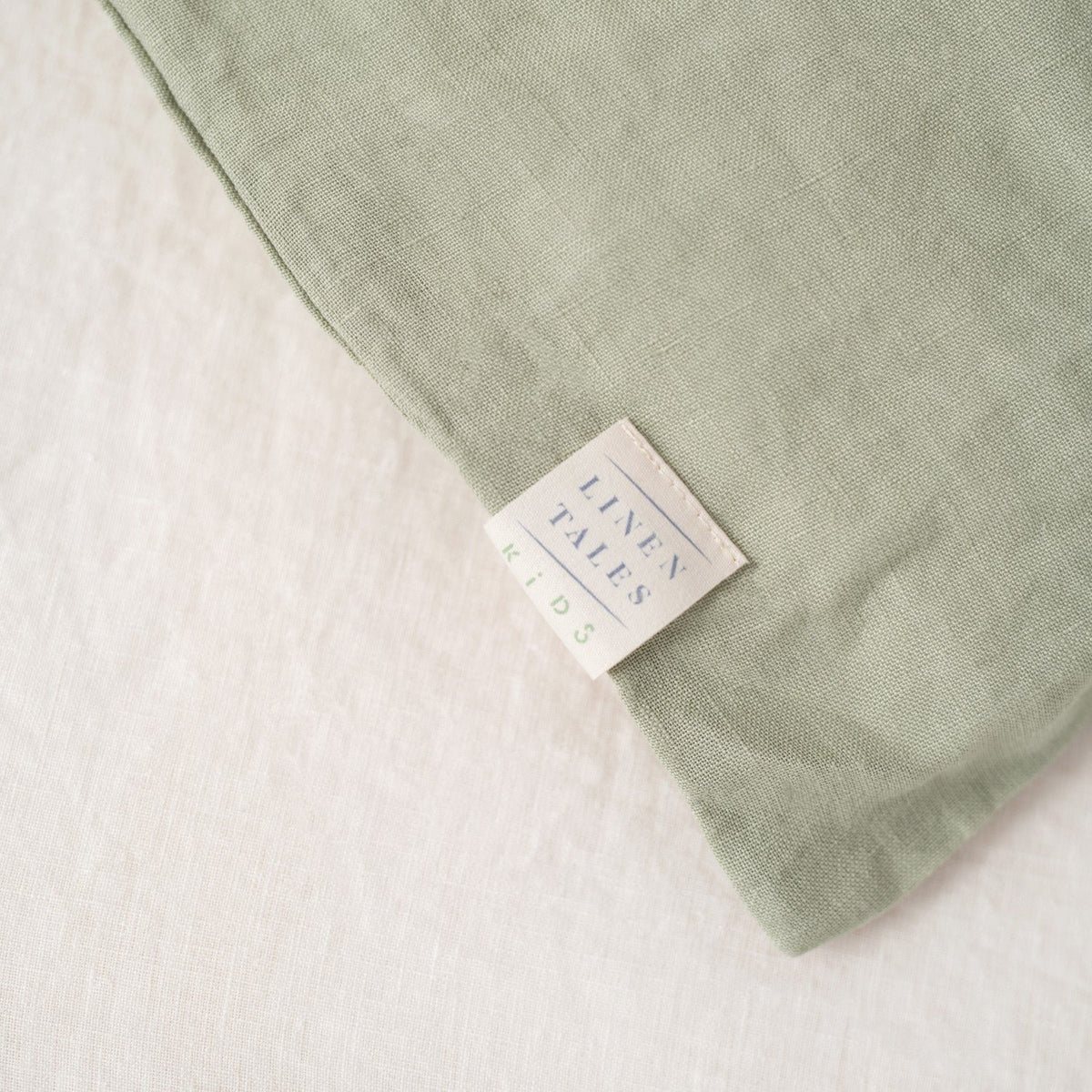 5. Close-up of Linen Tales label on sage green linen pillowcase