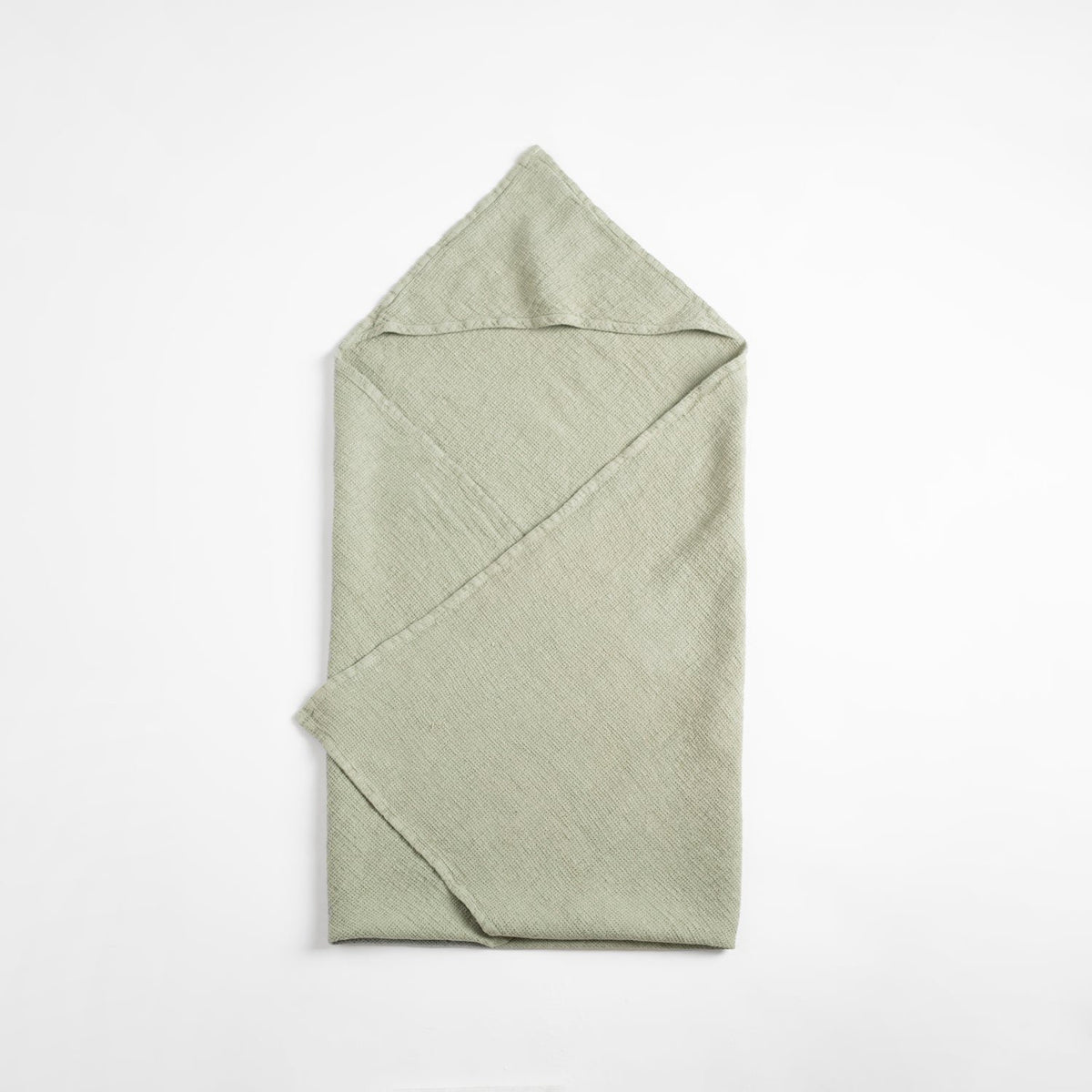 3. Flat lay of sage green linen hooded towel with waffle texture on white background