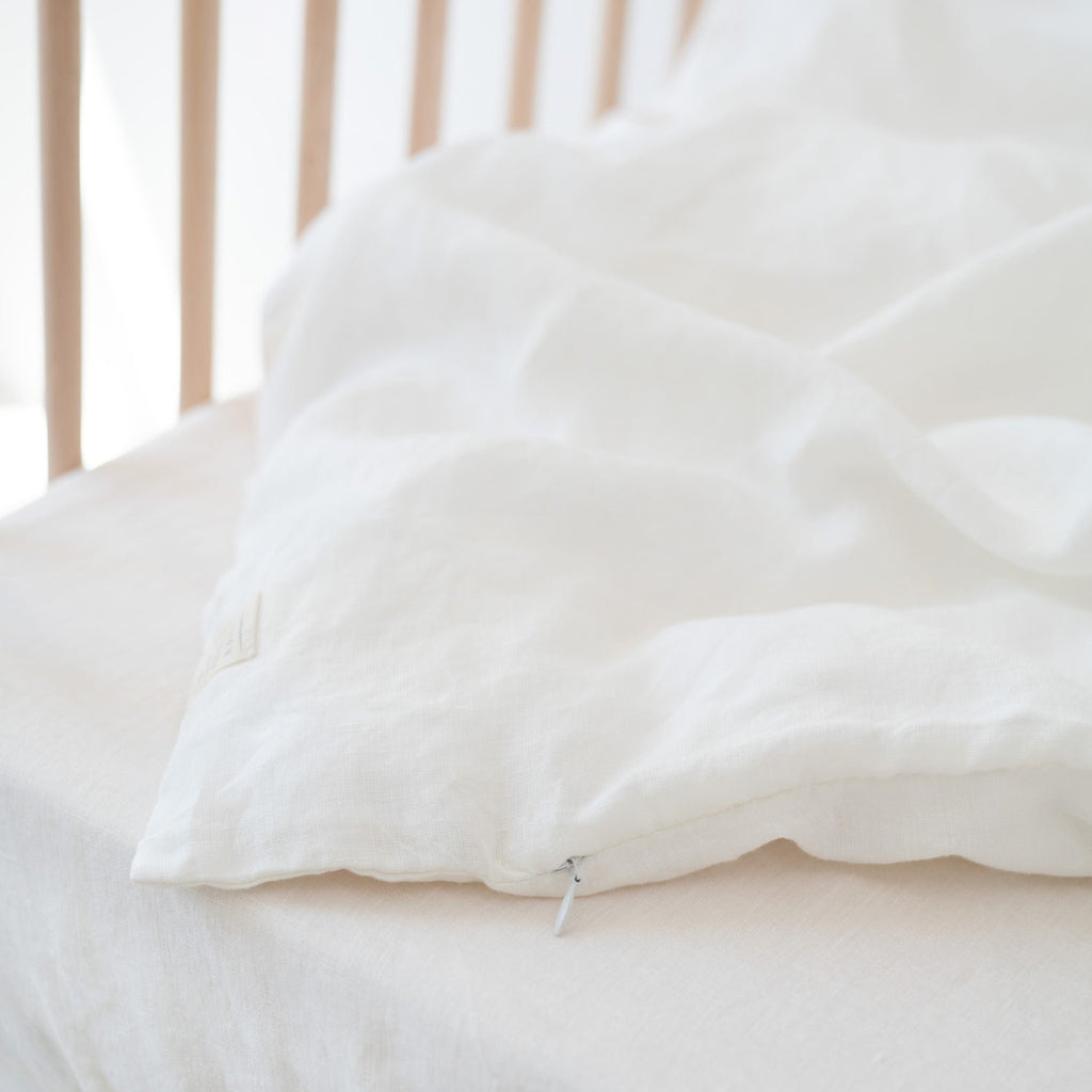 3. Close-up of white linen duvet cover with visible zipper detail