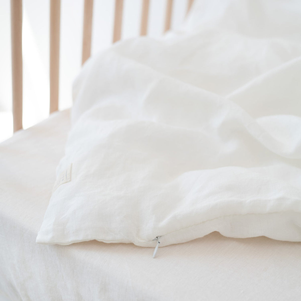 3. Close-up of white linen duvet cover with visible zipper detail
