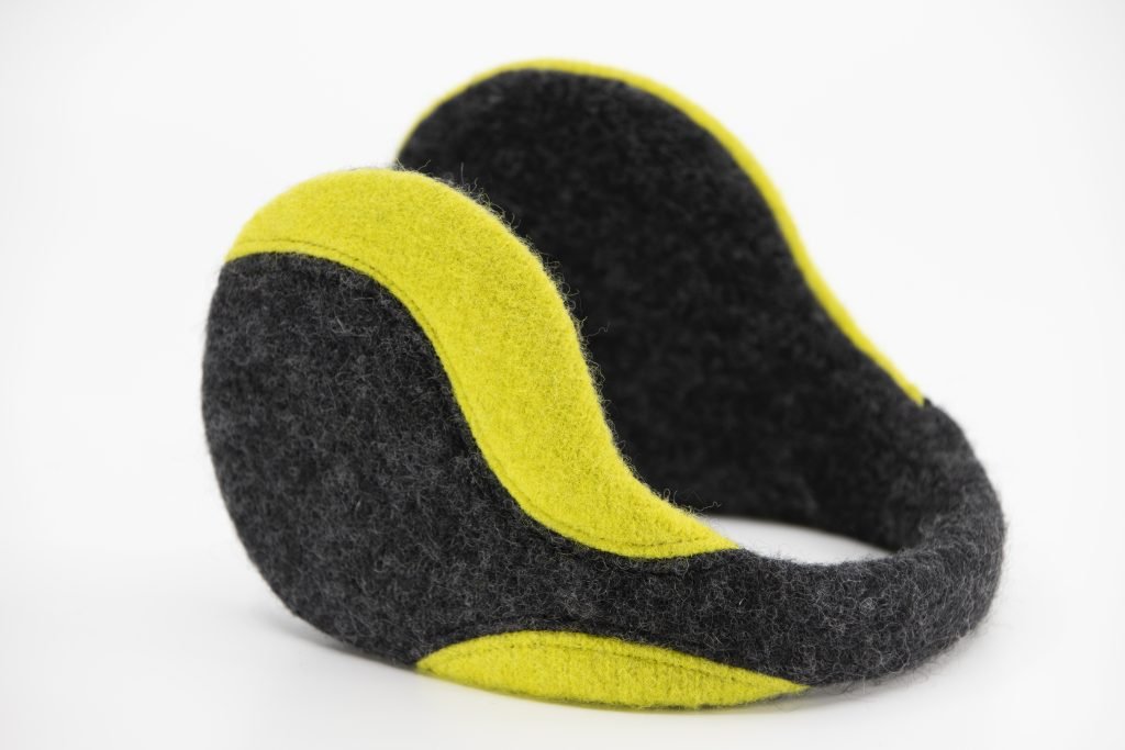 2. Studio image of HERTTA felted wool earmuffs in dark grey and apple green, showcasing design and color contrast