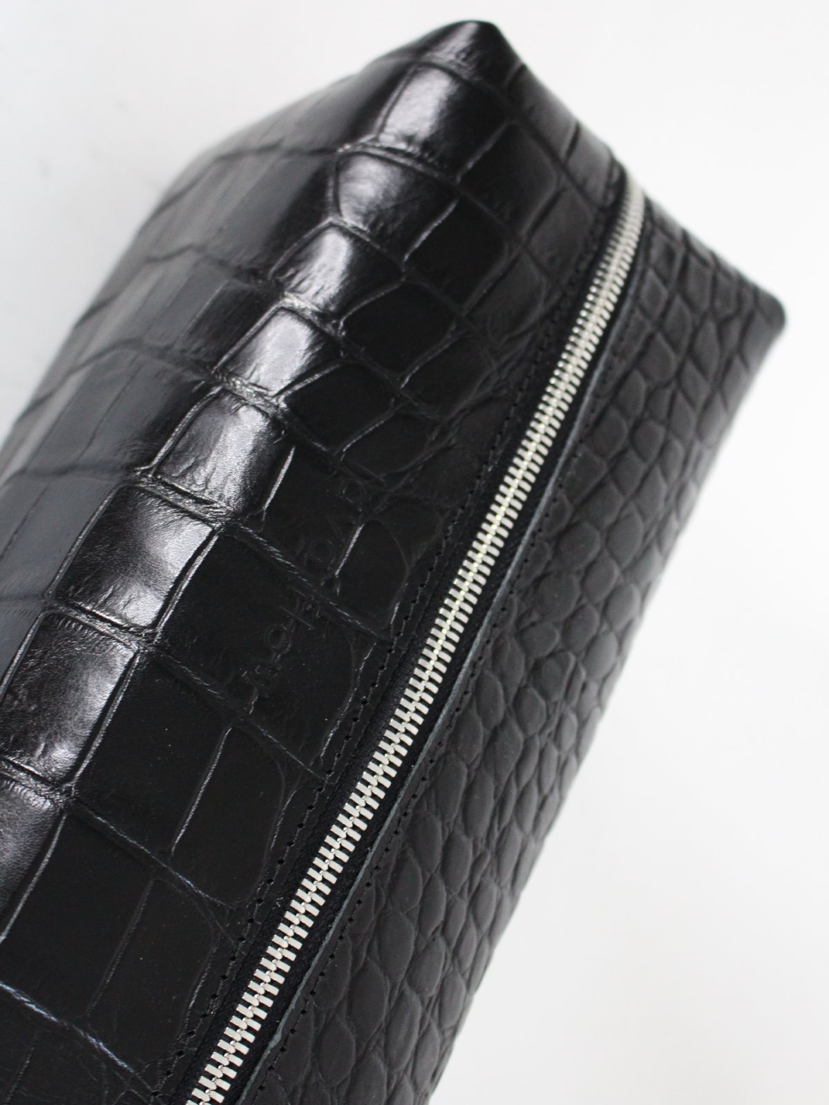 3. Close-up of Black Croco VESUVIUS cosmetic bag by Lava flow, showcasing croc-embossed leather and secure zipper