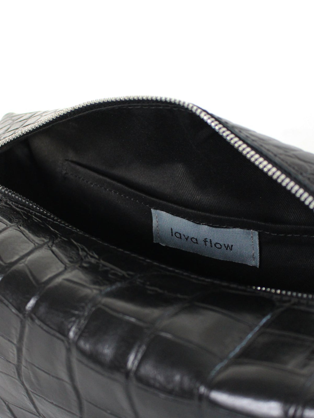 2. Interior view of Lava flow VESUVIUS cosmetic bag in Black Croco, highlighting brand label and cotton lining