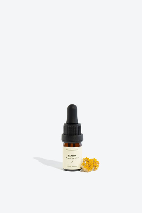 3. Smells Like Spells LEMON Essential Oil in 5 ml bottle with yellow flower accent, studio setting
