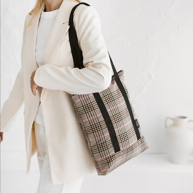 1. Women's tartan tote bag by Muni, styled with a cream blazer, showcasing chic everyday fashion
