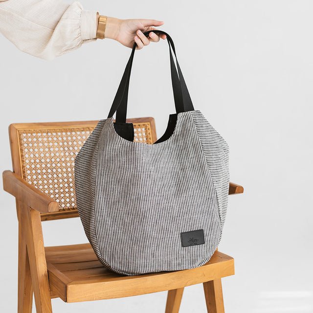 11. Muni striped linen tote bag on a wooden chair