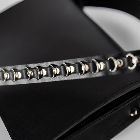 2. Close-up of PYKOK Lila Mini handbag's chic metal chain strap detail