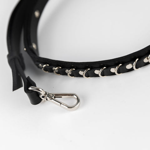 3. Close-up of PYKOK Lila Mini handbag's adjustable leather strap with clasp