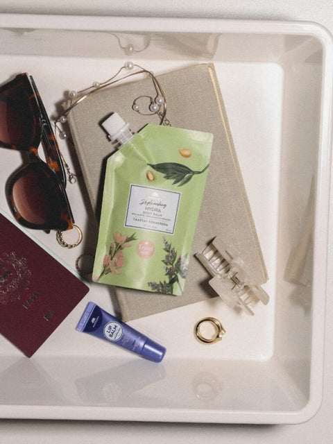 5. Magrada X Lauren Replenishing Body Balm travel size in a tray with travel essentials, highlighting convenience