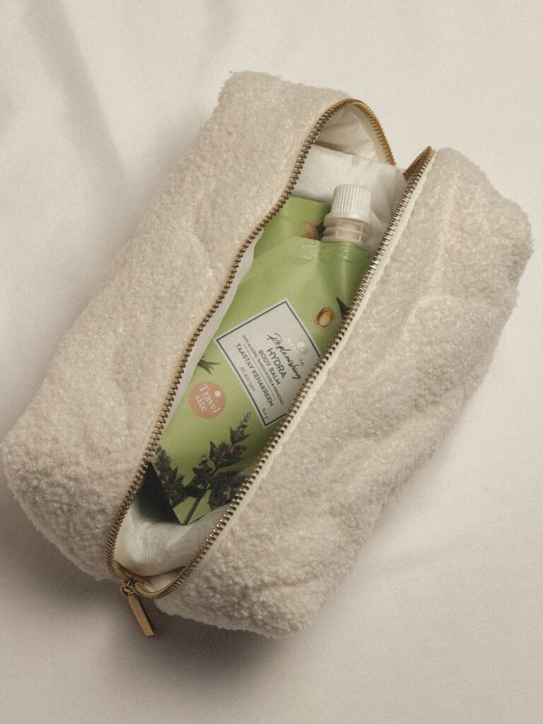 3. Magrada X Lauren Replenishing Body Balm travel size in a white textured pouch, emphasizing portability