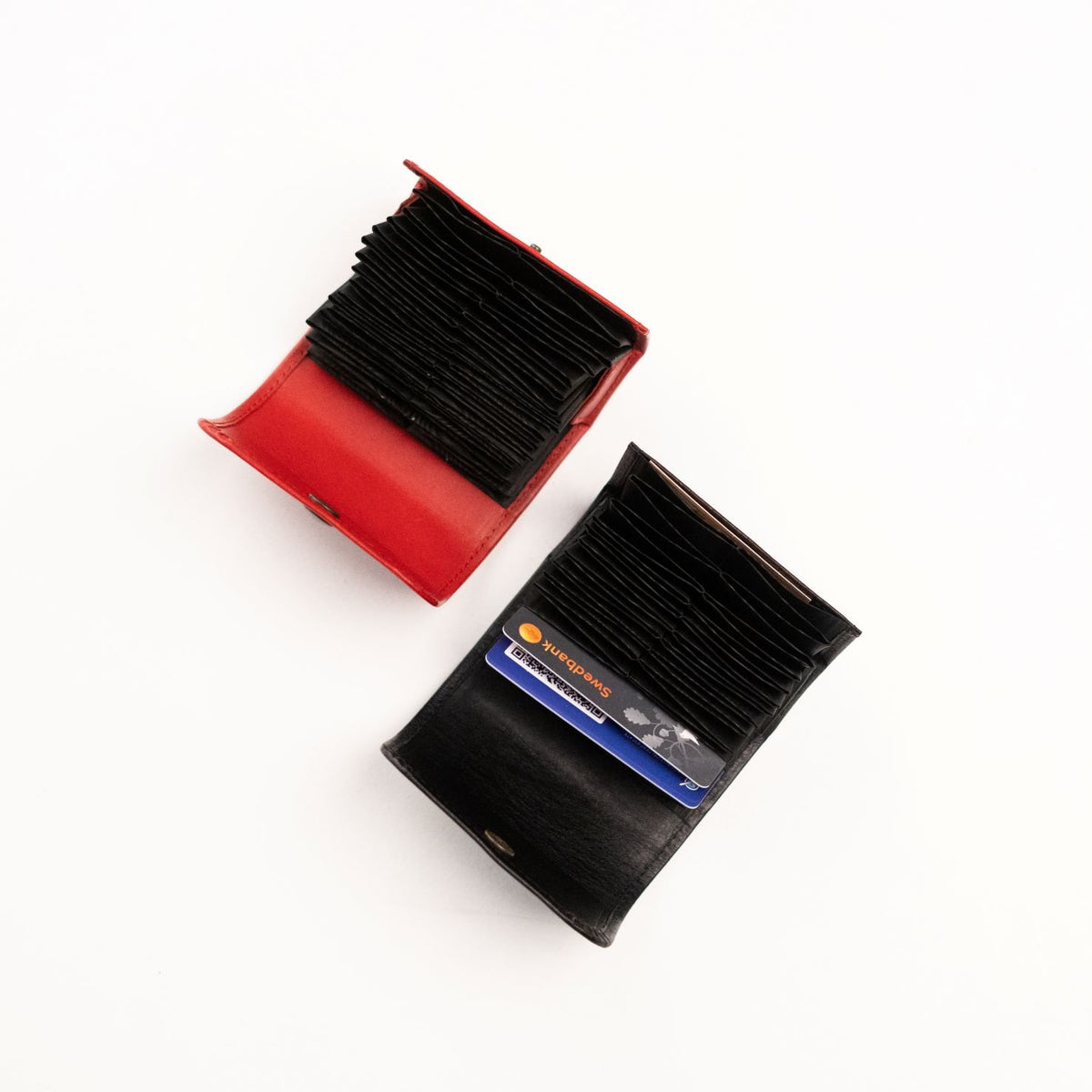 3. Studio shot of Papillon leather card holders in red and black, highlighting compact design and card capacity