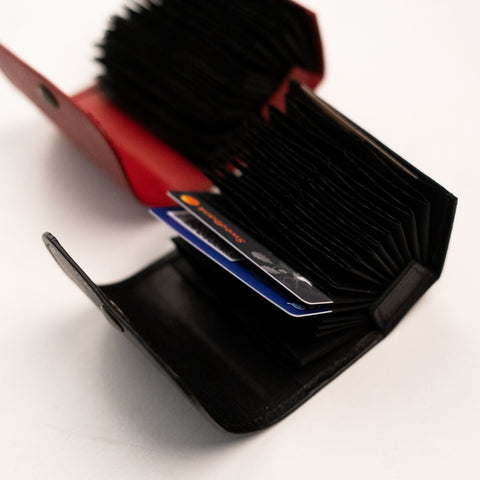 2. Close-up of Papillon leather card holders in red and black, showcasing card slots and craftsmanship
