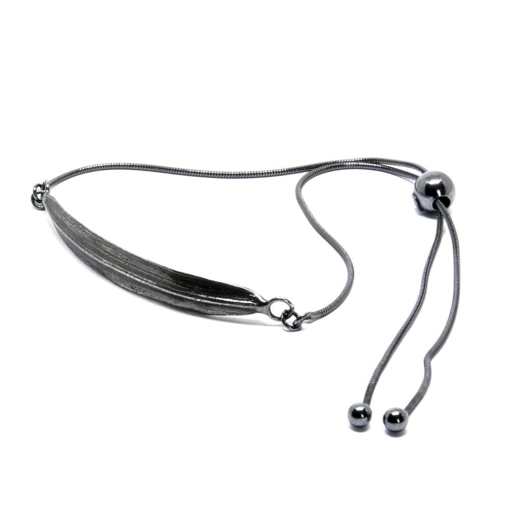 2. Dark-toned SPRING Leaf bracelet by Agnes Veski Jewellery, featuring adjustable chain and leaf motif in studio setting