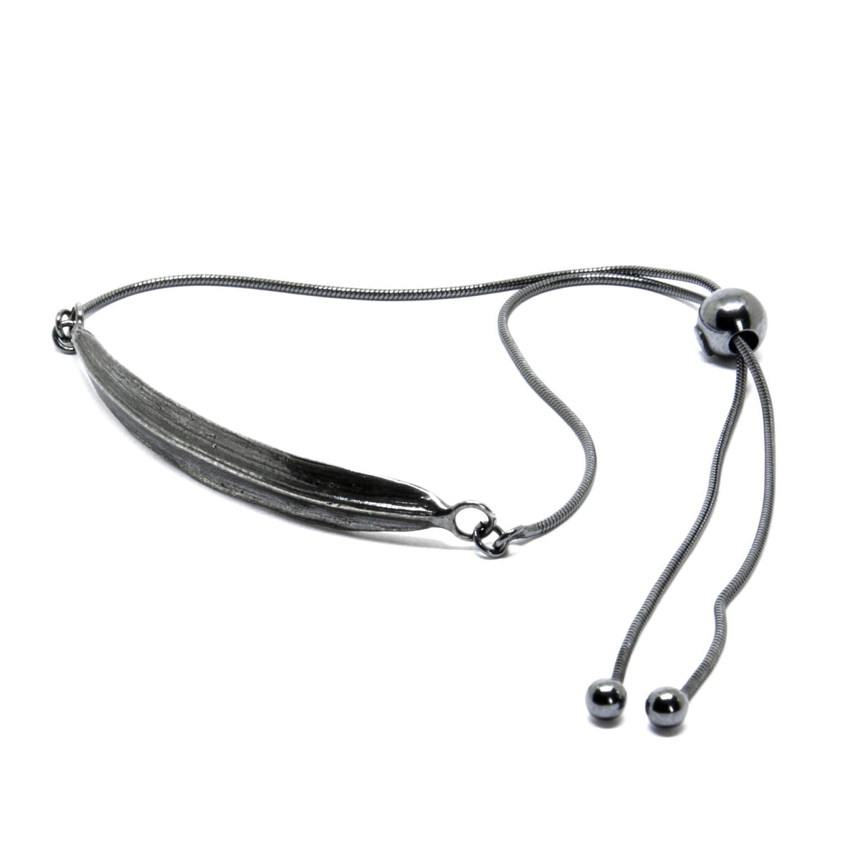 2. Dark-toned SPRING Leaf bracelet by Agnes Veski Jewellery, featuring adjustable chain and leaf motif in studio setting