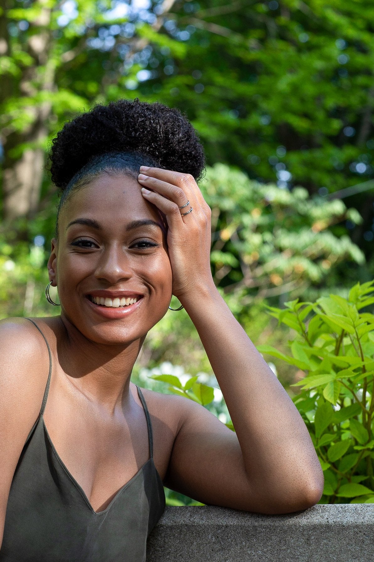 1. Woman smiling outdoors wearing Lentsius Linea stainless steel earrings, showcasing eco-conscious Scandinavian design