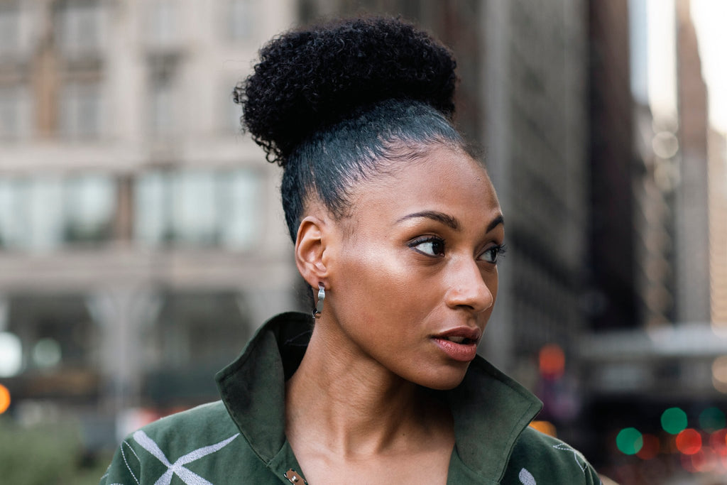 1. Woman wearing Lentsius Mare stainless steel earrings in urban setting