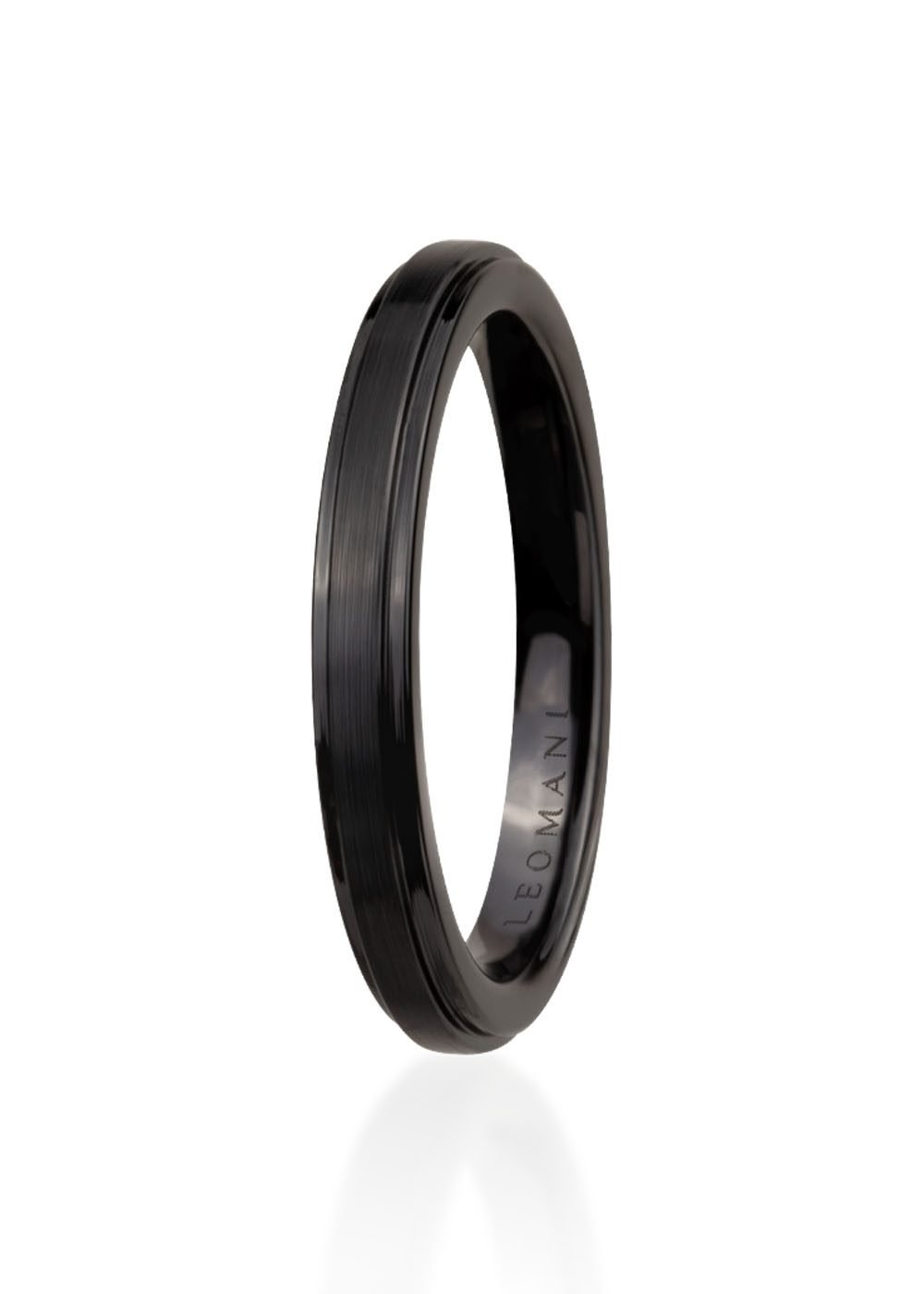 2. Men's black ceramic ring by Leomani shown in studio with engraved logo