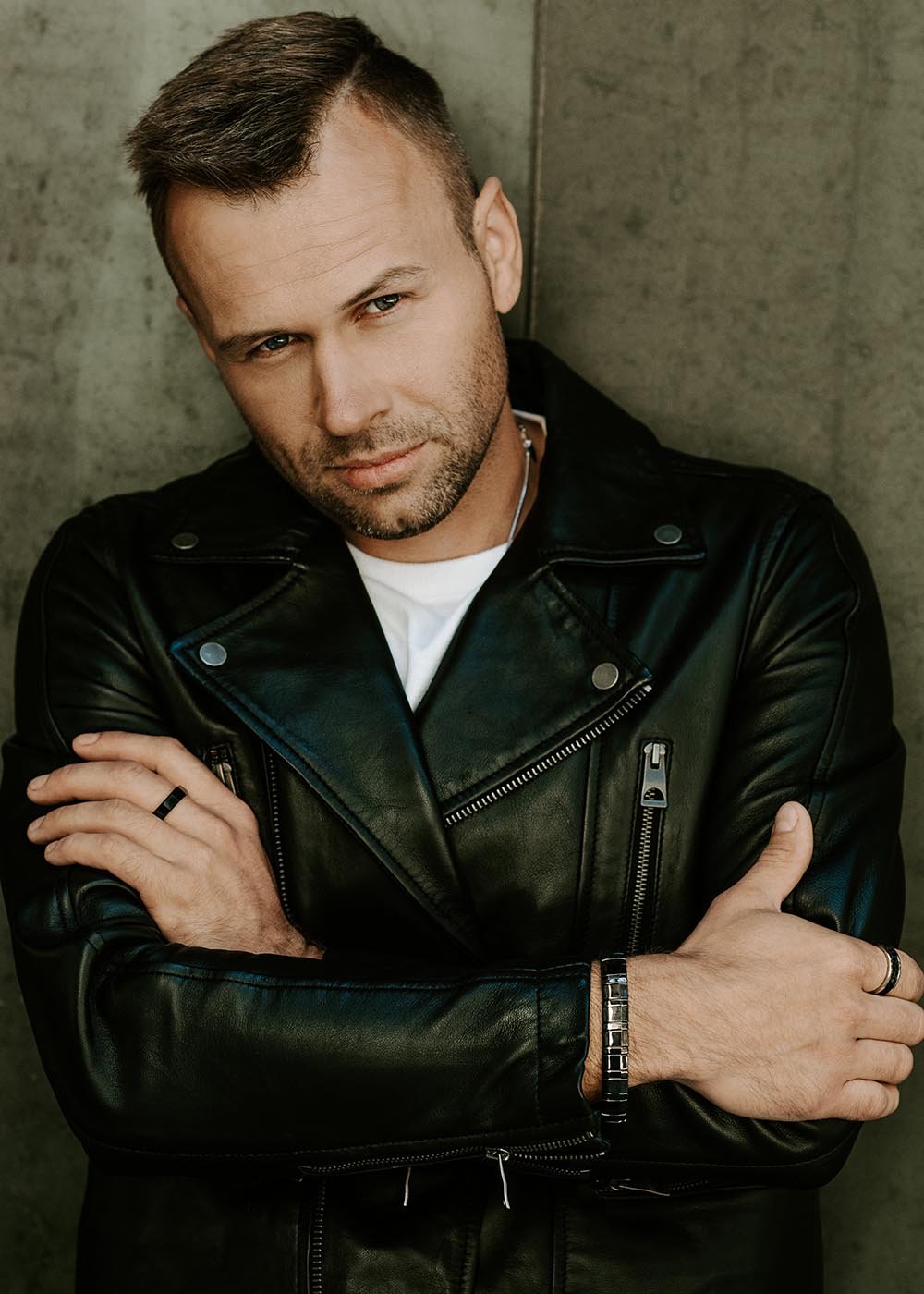 1. Man in black leather jacket wearing Leomani Bonard black ceramic bracelet crossing arms