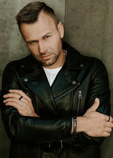 1. Man in black leather jacket wearing Leomani Bonard black ceramic bracelet crossing arms