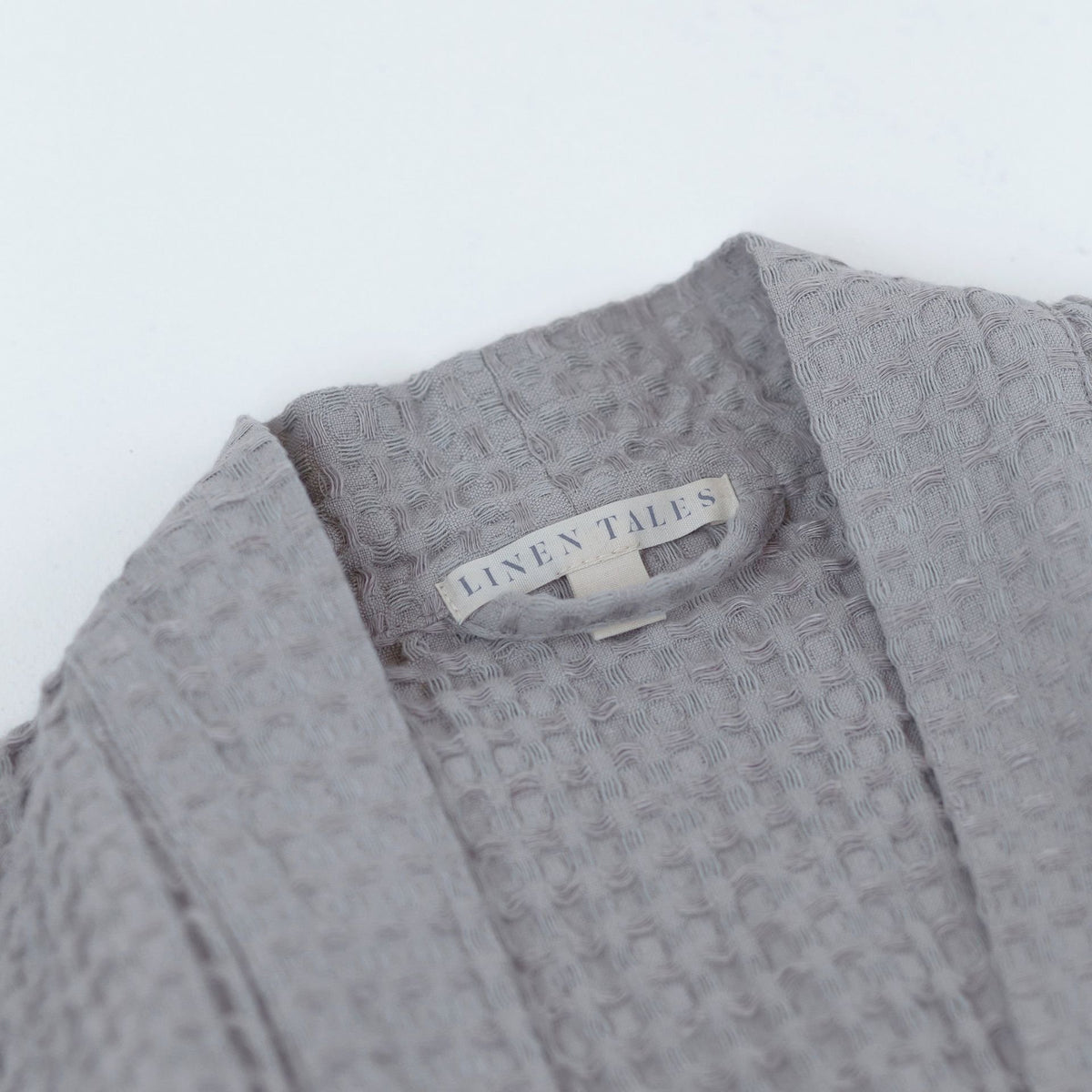 3. Close-up of Linen Tales label on light grey honeycomb waffle fabric