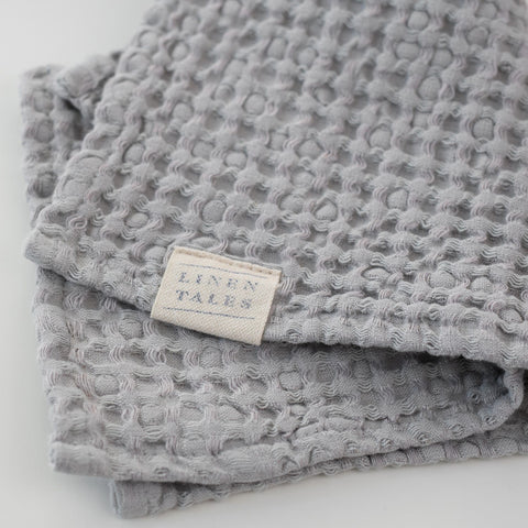 4. Light grey honeycomb waffle towel with Linen Tales label, highlighting brand and texture