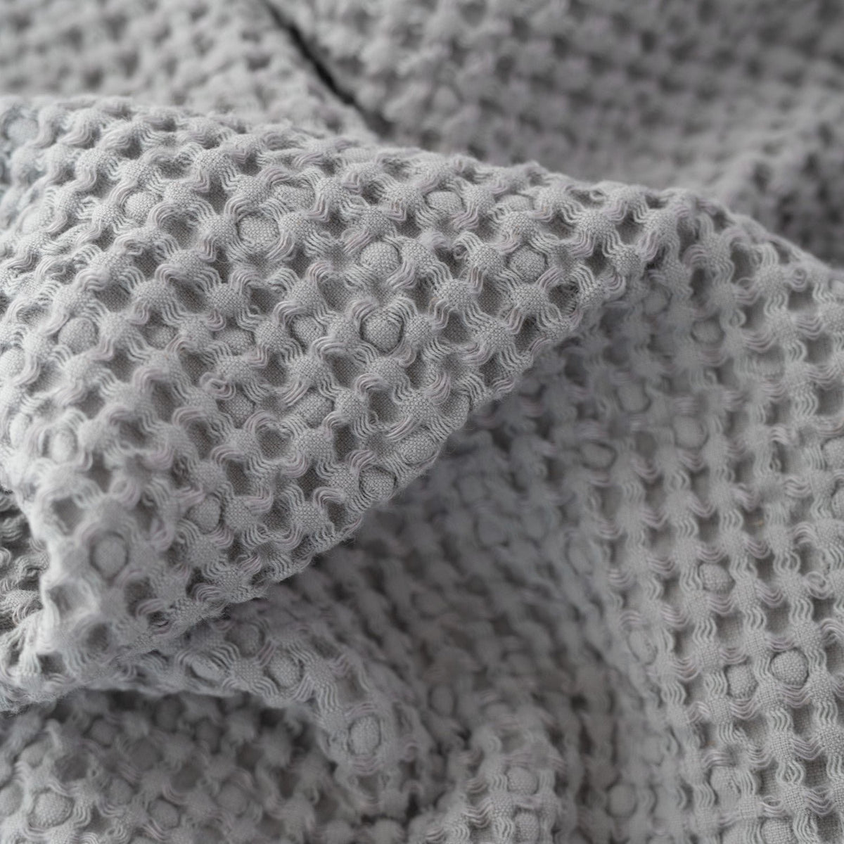 7. Close-up of light grey honeycomb waffle towel fabric, emphasizing texture and weave