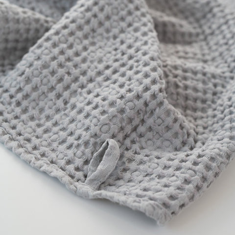 3. Light grey honeycomb waffle towel with hanging loop detail, showing texture and weave