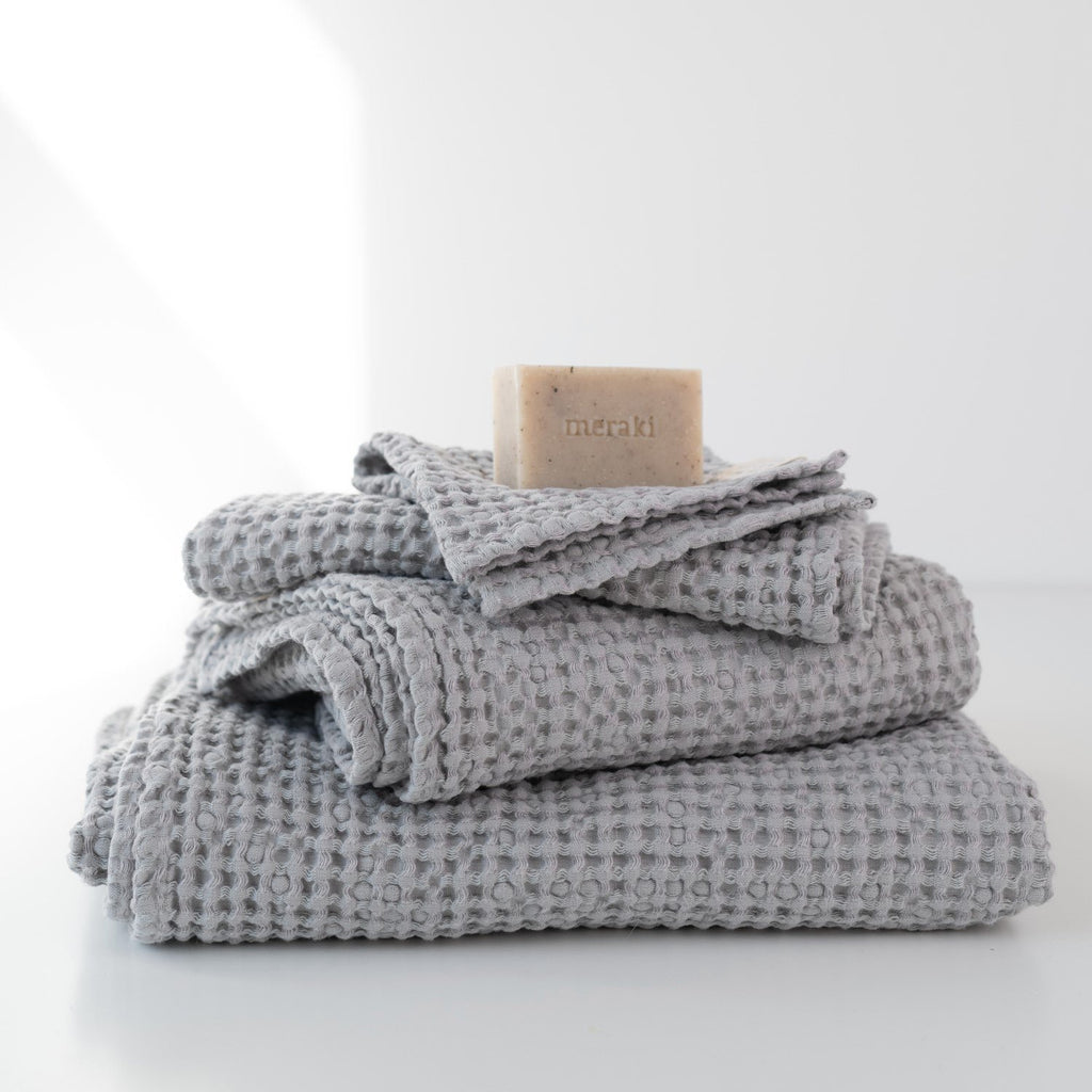 5. Light grey honeycomb waffle towels stacked with soap, highlighting texture and spa-like feel