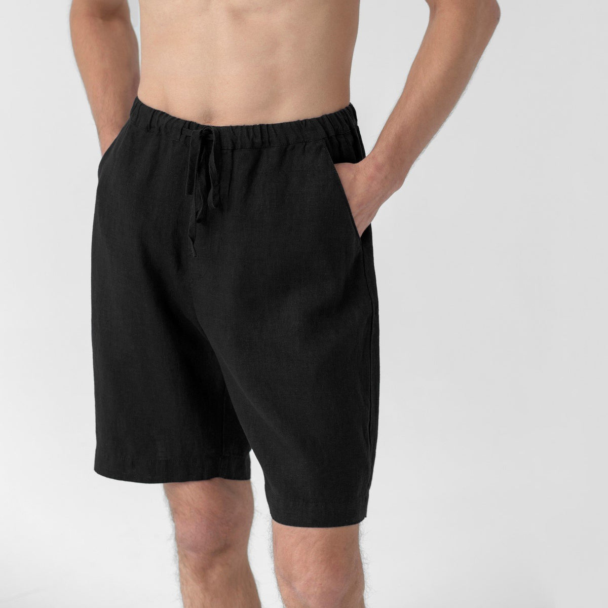3. Close-up of black linen pyjama shorts with elasticated waistband and drawstring, showing side pockets