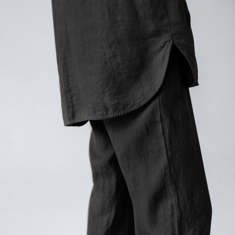 3. Close-up of black linen loungewear showing rounded slits in side seams and fabric texture