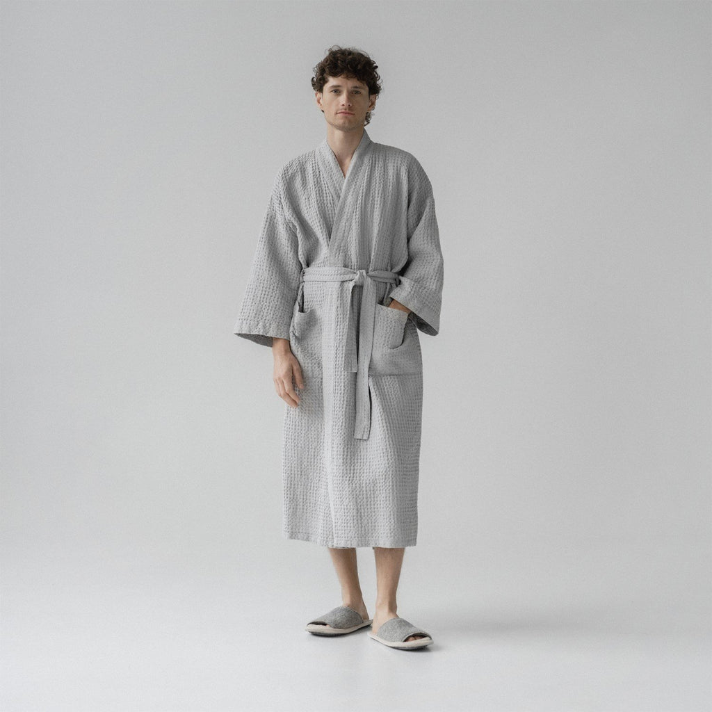 6. Man wearing light grey honeycomb waffle bathrobe with adjustable waist tie in studio
