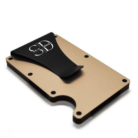 2. Angled view of gold Seif Design card holder with black clip, highlighting minimalist design and aluminum material