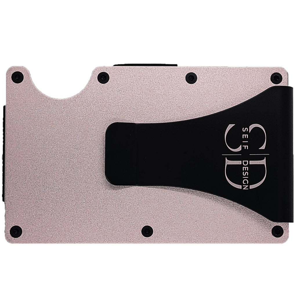 1. Close-up of Seif Design pink metal cardholder with black money clip and logo, showing durable aluminum construction