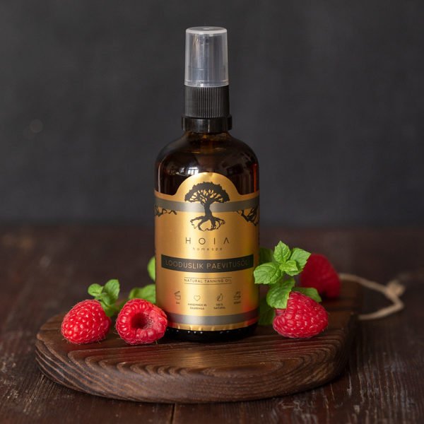 1. HOIA homespa Natural Tanning Oil bottle with raspberries and mint leaves on a wooden surface, highlighting natural ingredients