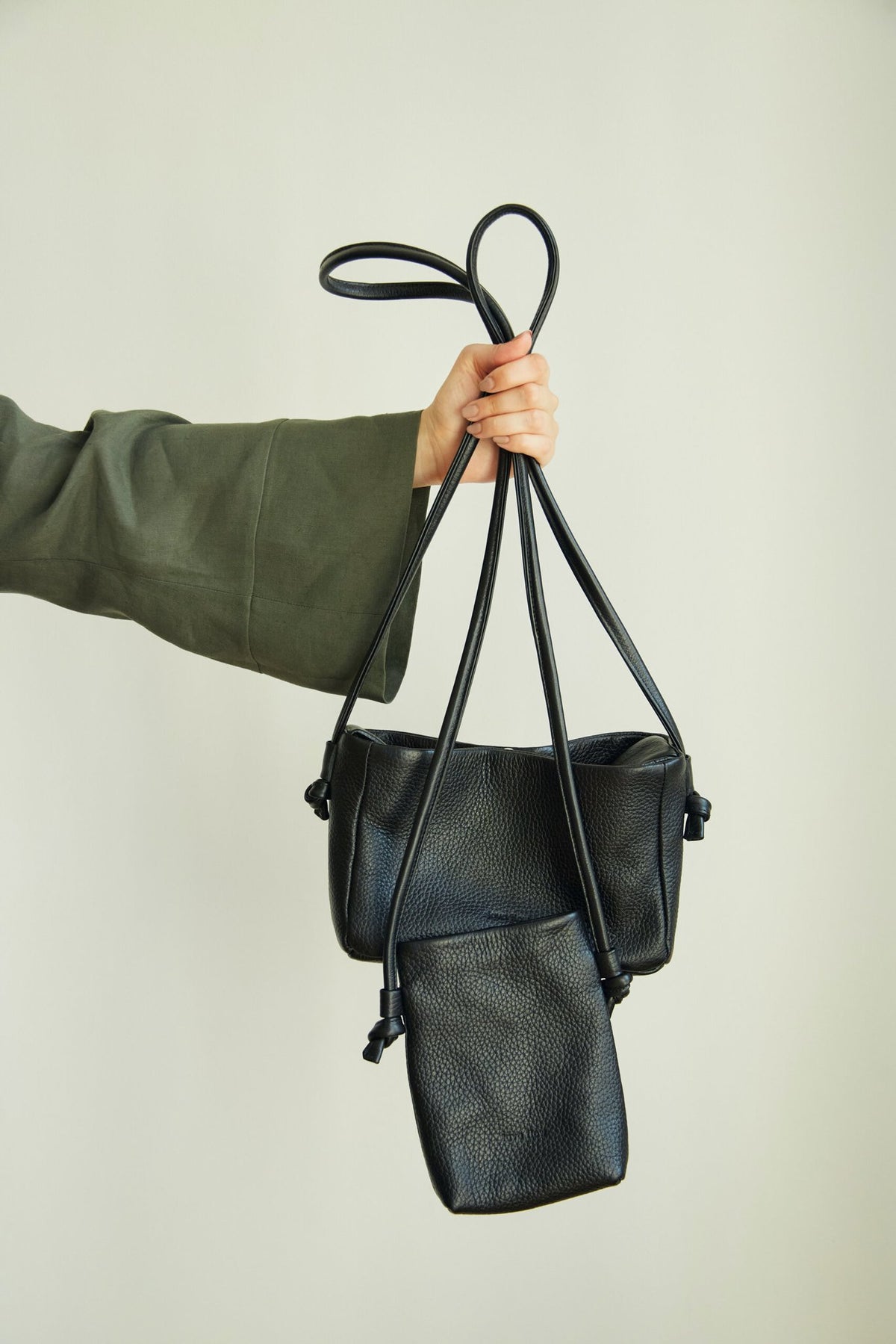 6. Close-up of Lava Flow Crossbody Bag MERU in black, showing adjustable straps and texture