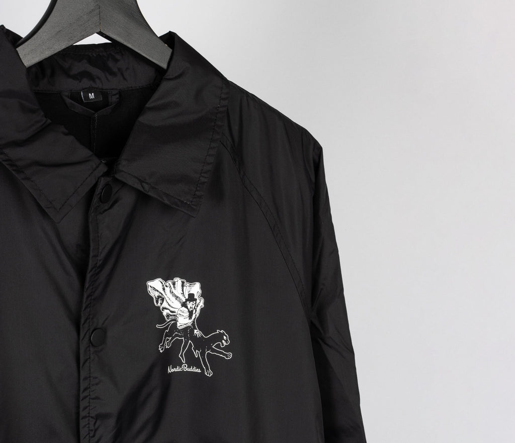7. Close-up of front logo on unisex black Coach Jacket The Hobgoblin by Moomin