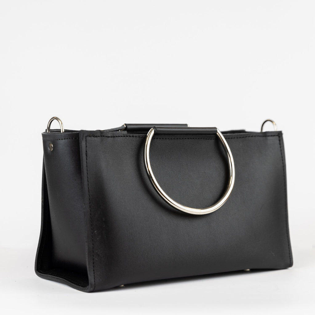 7. Studio image of PYKOK Handbag Maria Mini in black leather with metal handles