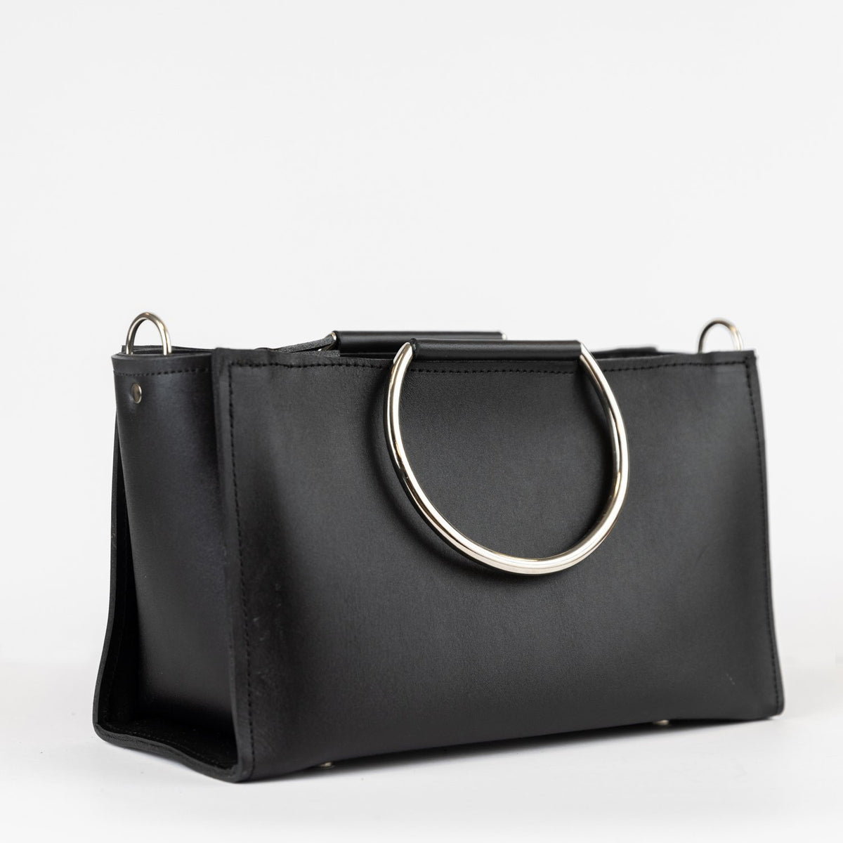7. Studio image of PYKOK Handbag Maria Mini in black leather with metal handles