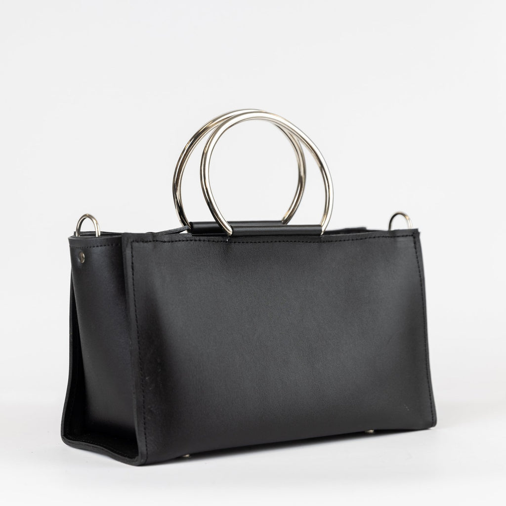 2. Black leather Handbag Maria Mini by PYKOK with metal handles, studio shot