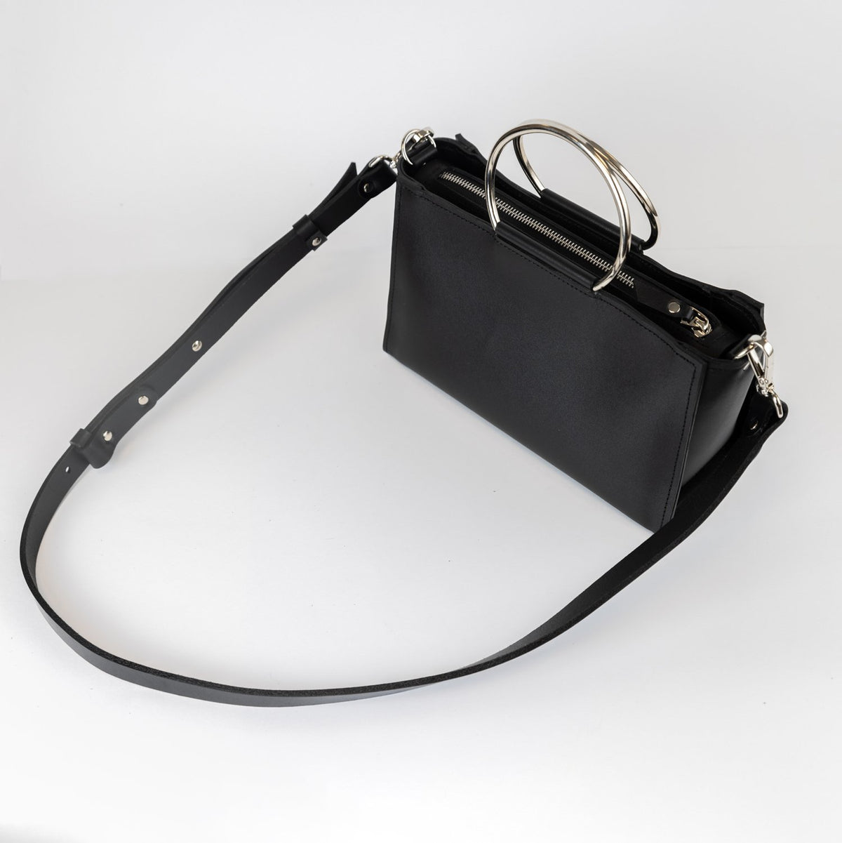 8. Black leather Handbag Maria Mini by PYKOK with adjustable strap, studio view