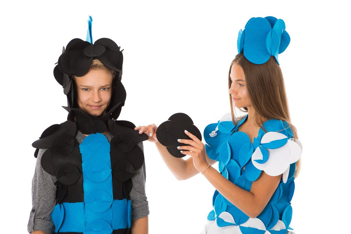 3. Close-up of two people in blue and black felt costumes, one adjusting the other's costume piece