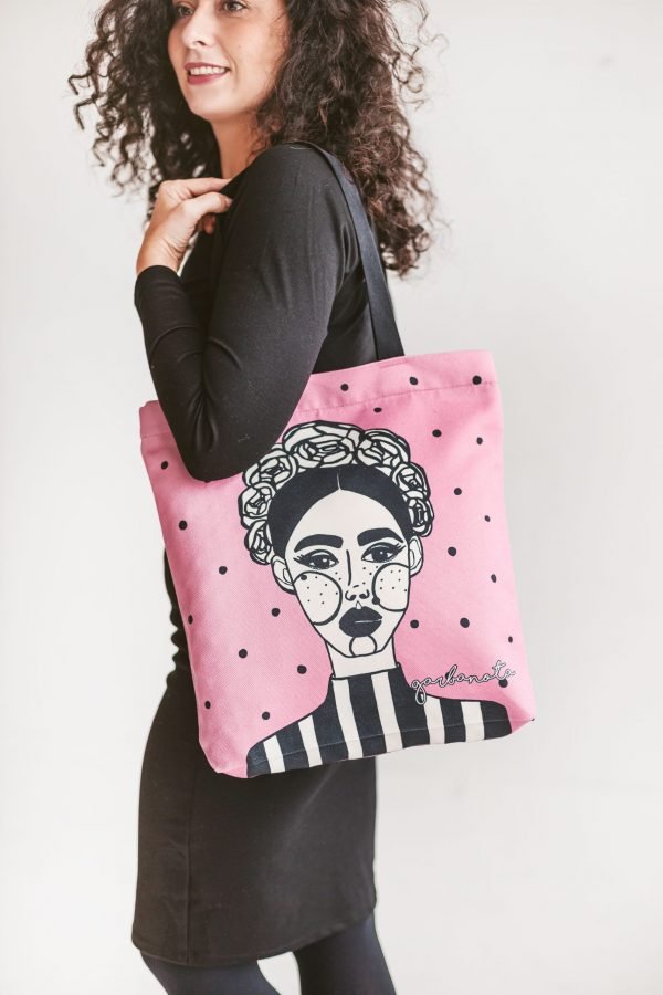 3. Woman in black dress showcasing Garbanota HANDBAG MARGO in pink with unique artwork