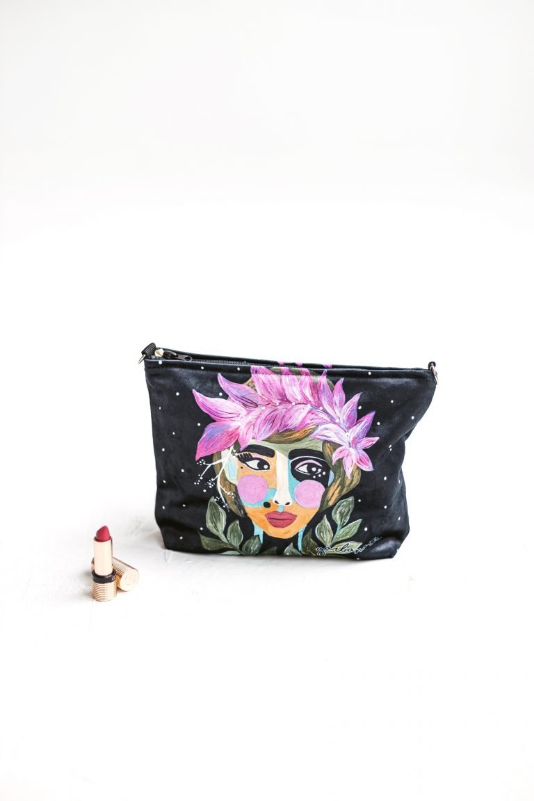 1. Garbanota makeup bag in Forest Berry design held by a woman, showcasing artistic print and versatile size
