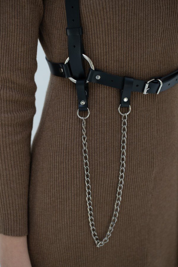 6. Close-up of metal chain detail on Body Harness Milla by PYKOK, worn over a brown dress