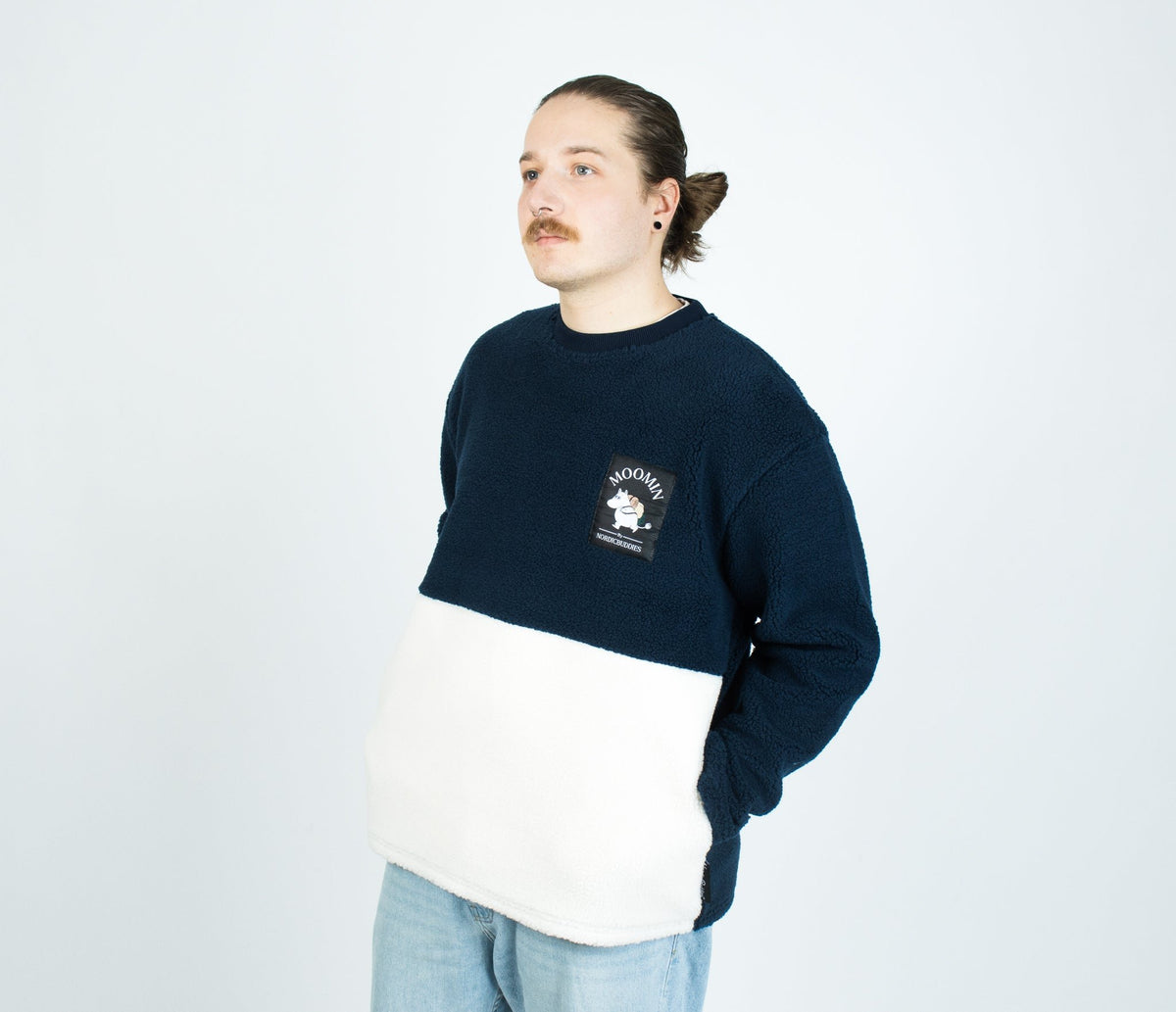 4. Man wearing Moomin by NordicBuddies navy and white fleece, front view in studio