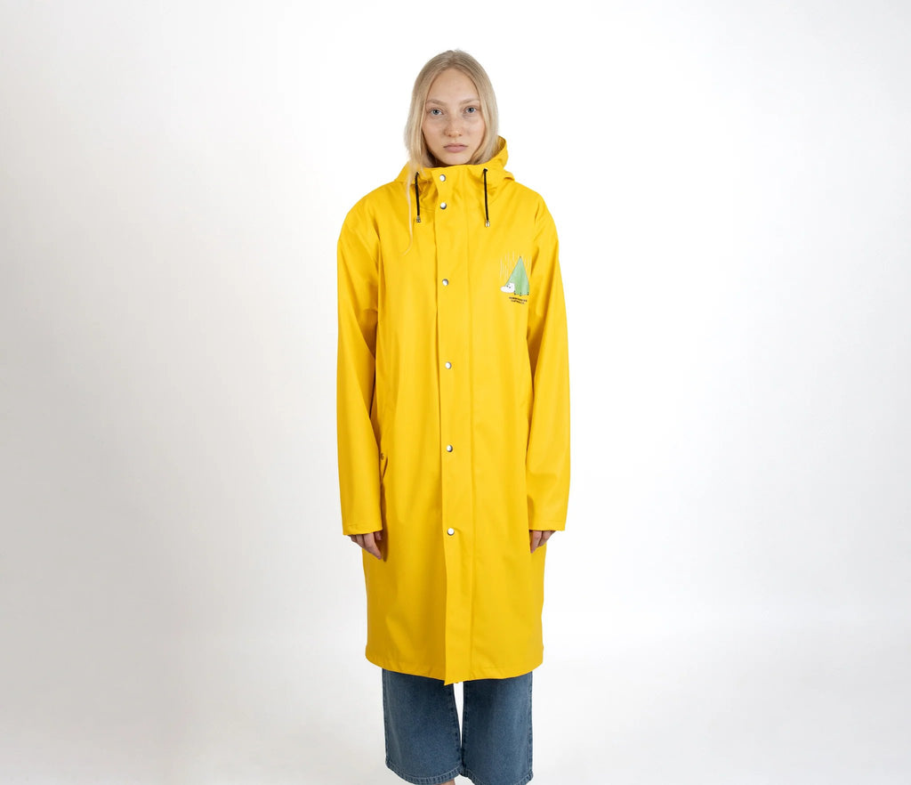 6. Female model wearing unisex yellow Moomin Adventure Rain Jacket in studio setting